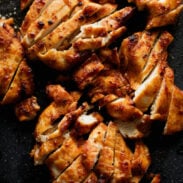 Sliced chicken on a cutting board.