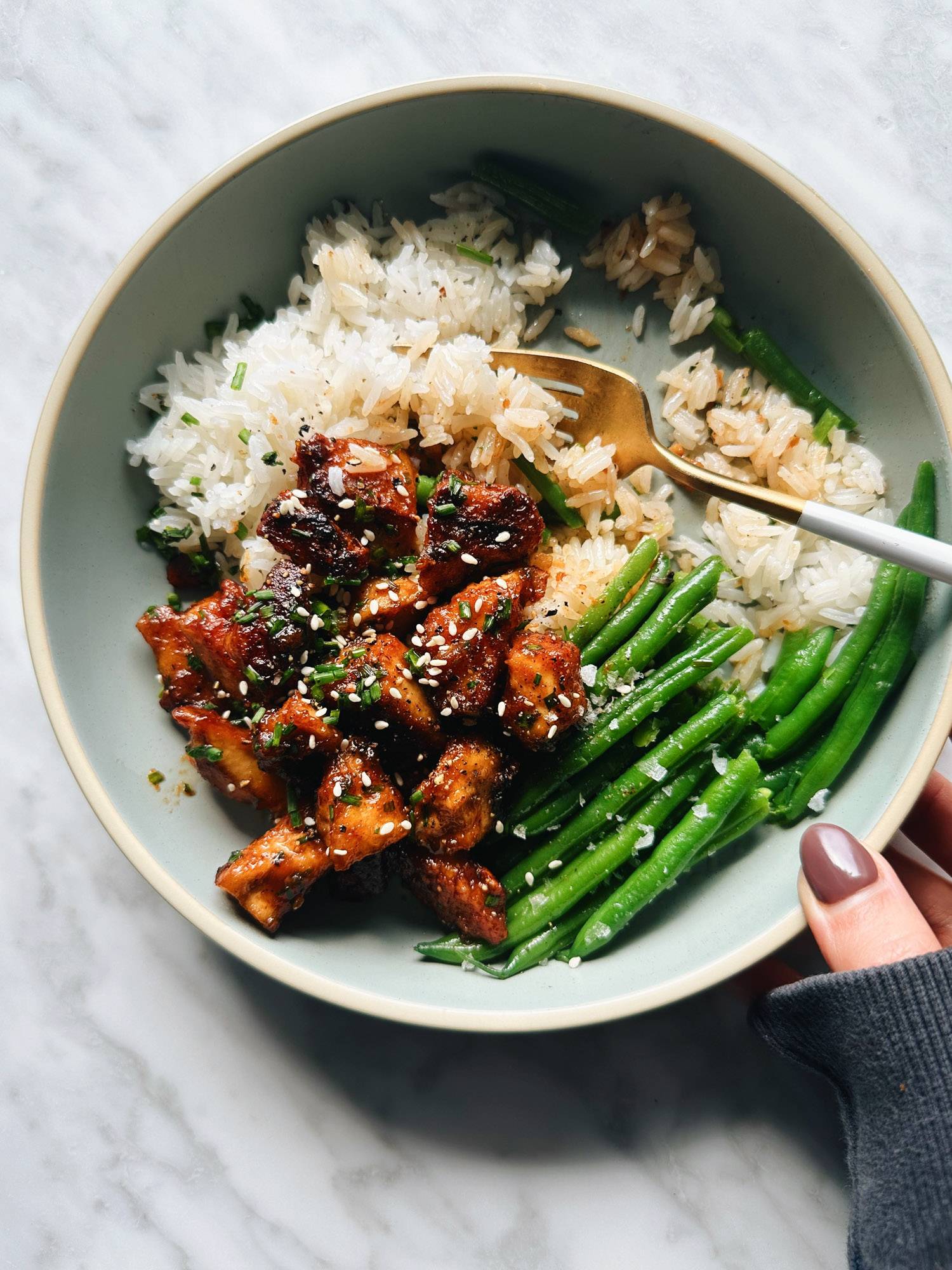 Sesame apricot tofu in a bowl with rice and green beans.