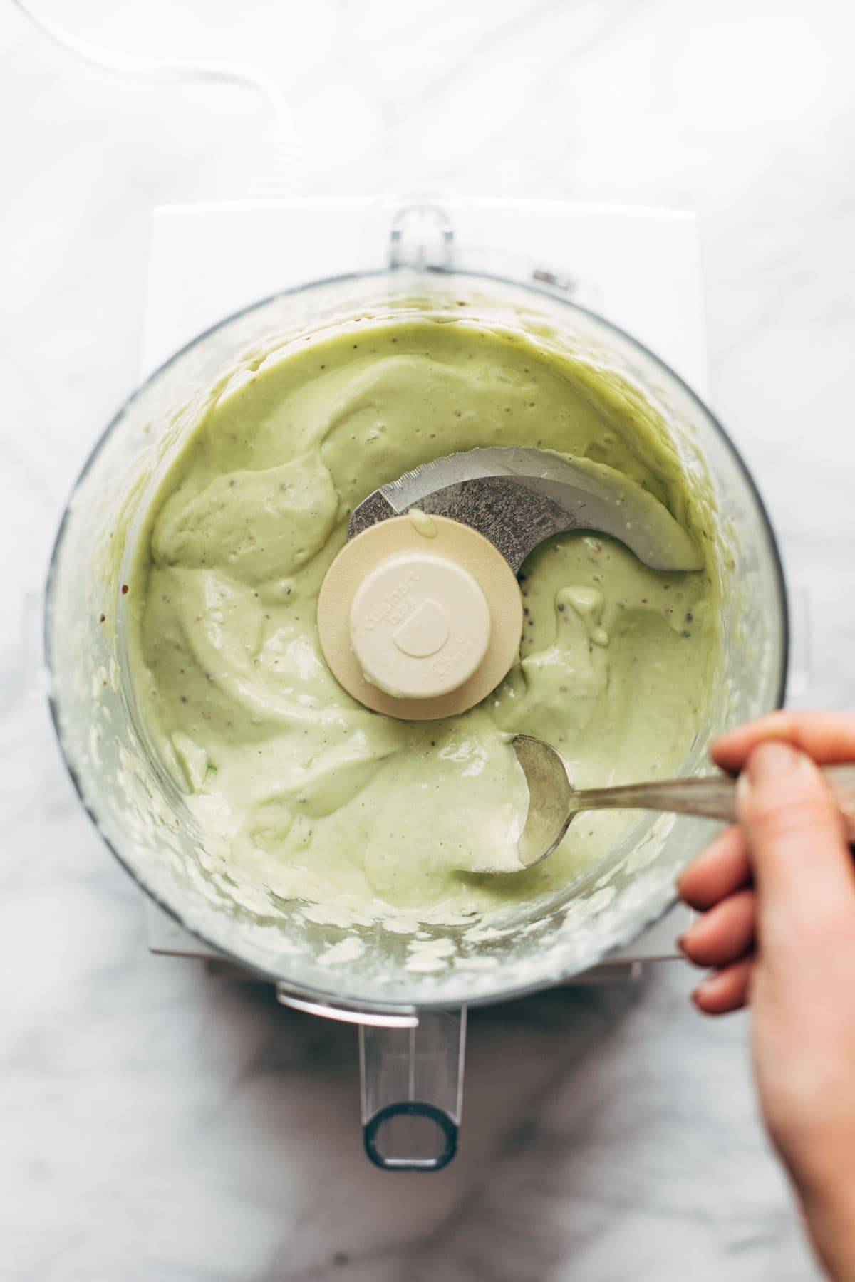 Avocado caesar dressing in food processor.