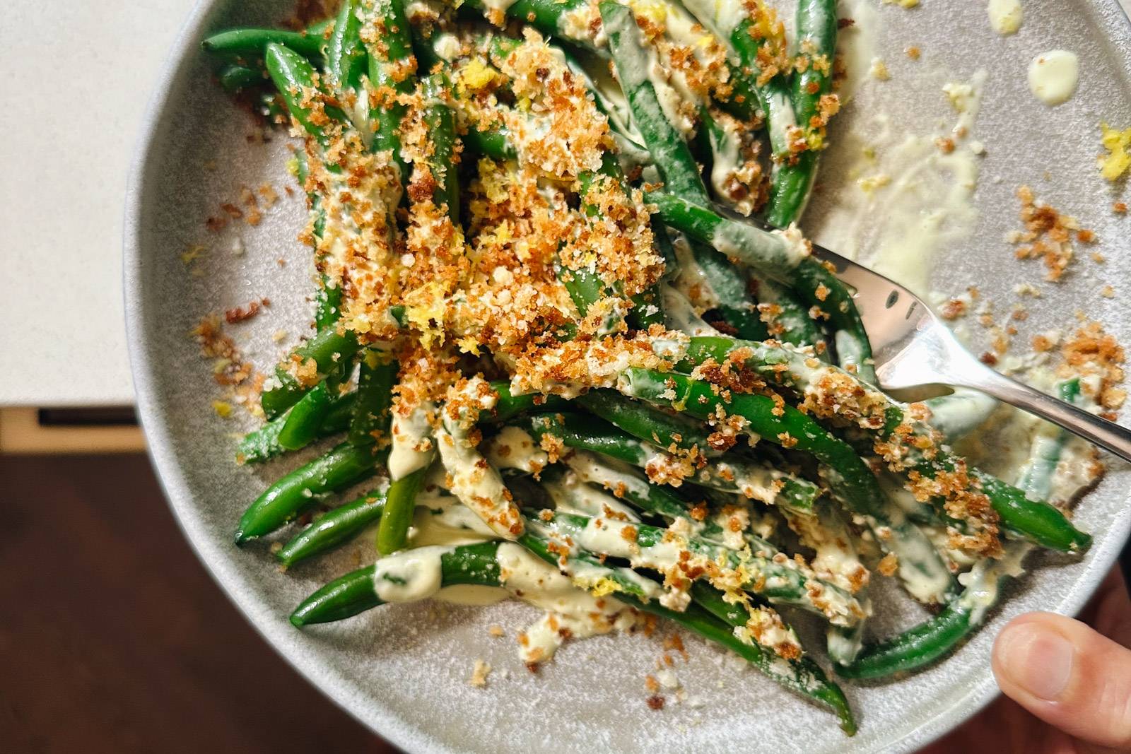 Caesar green beans on a plate with crispy panko.