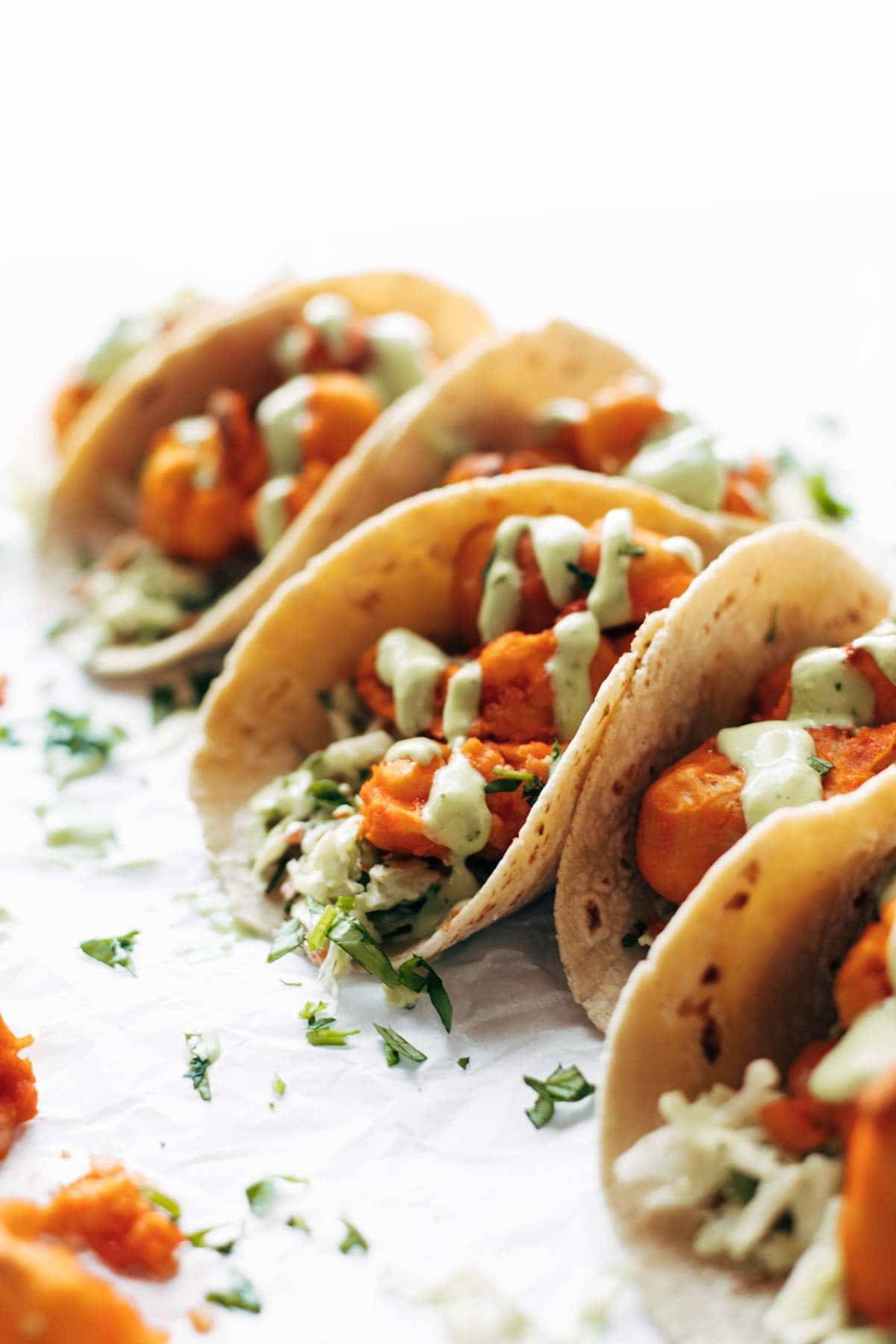 Buffalo cauliflower tacos with avocado crema.