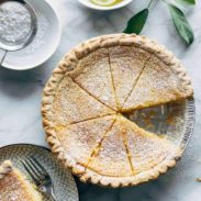 Lemon pie with slice on a plate.