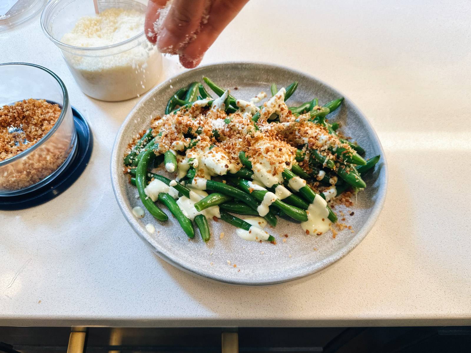 Sprinkling crispy panko on top of caesar green beans.