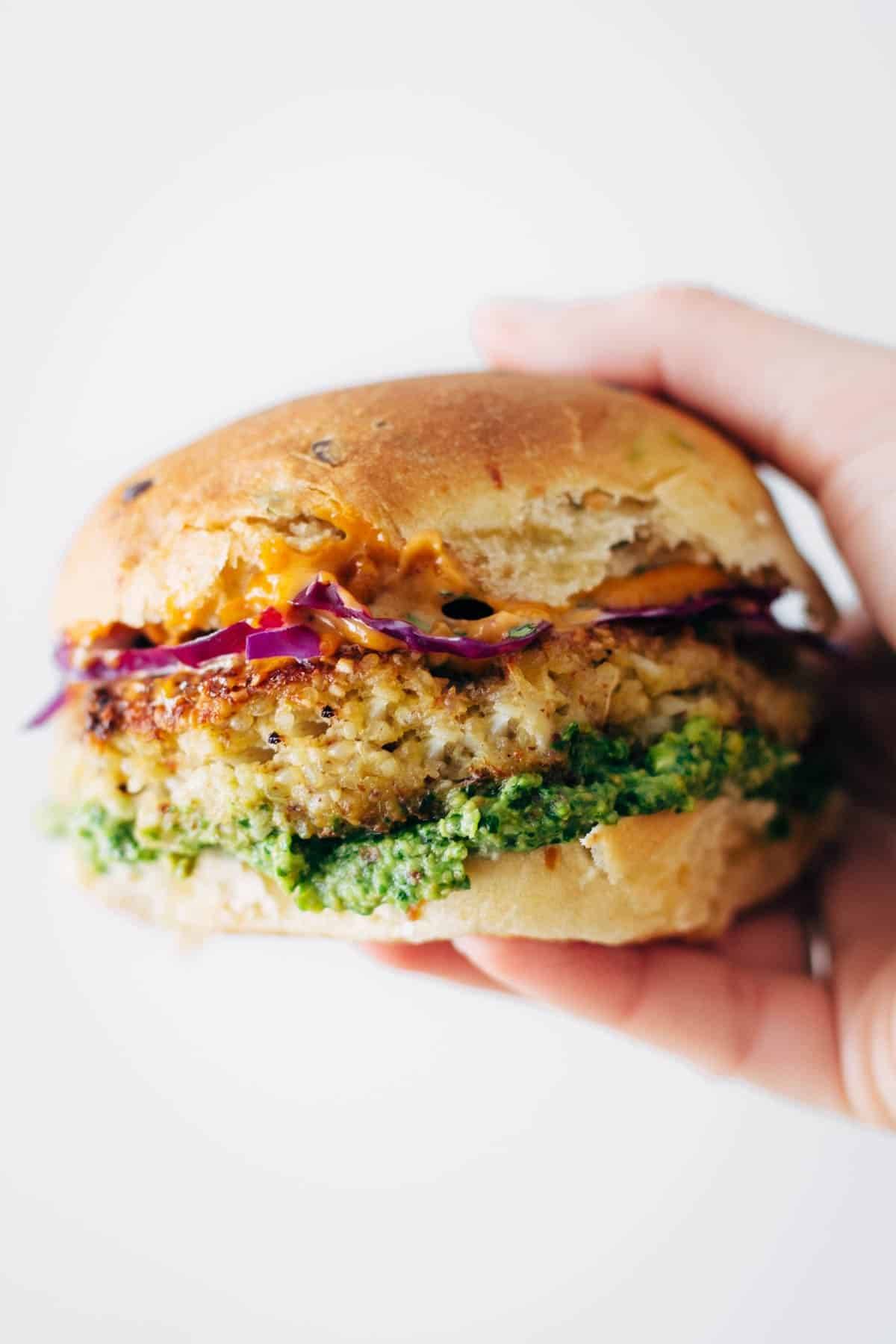 Recipe for Spicy Cauliflower Burgers with avocado sauce, cilantro lime slaw, and chipotle mayo! Meatless, filling, and delicious! | pinchofyum.com