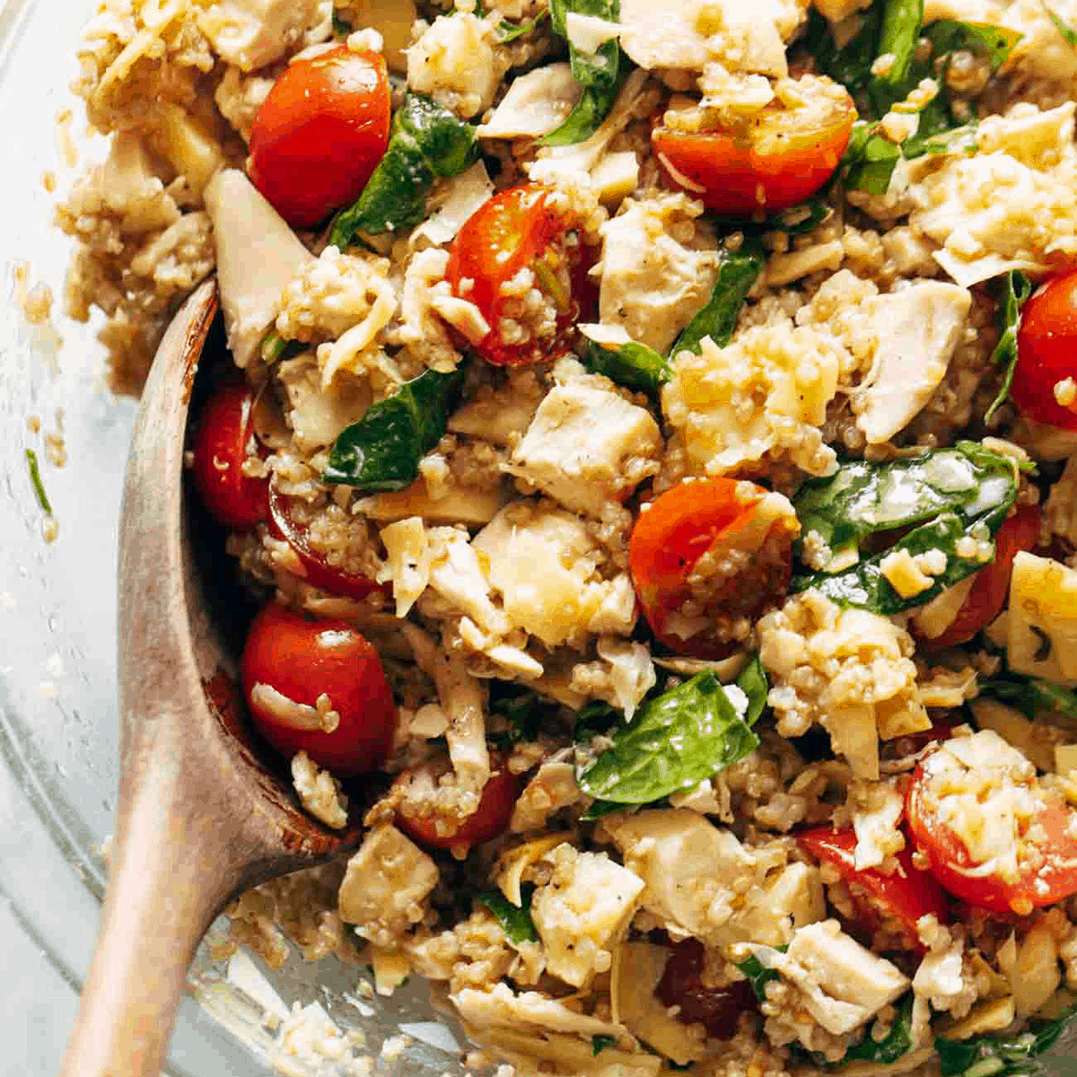 Chicken salad in a bowl made with quinoa and tomatoes.