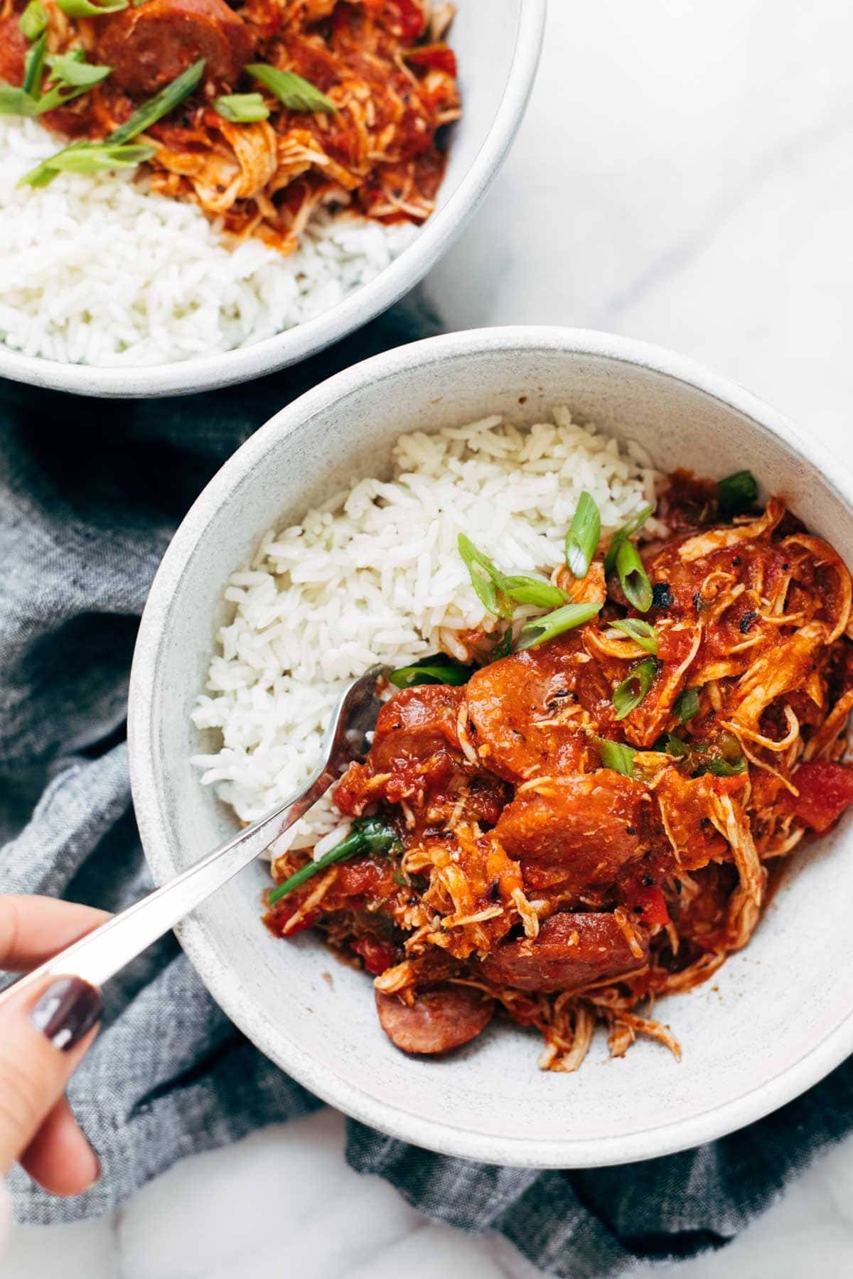 Creole chicken and sausage in bowls with rice.