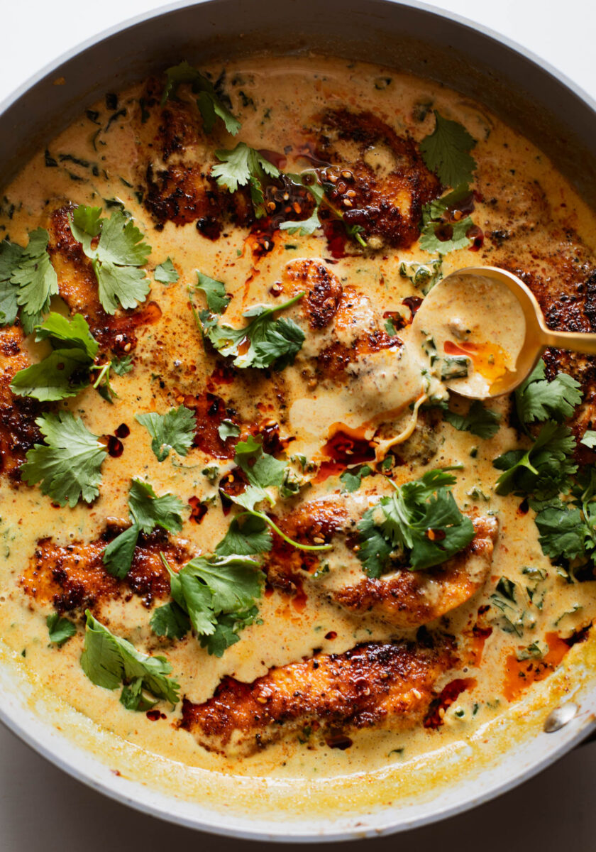 Chicken in a coconut sauce in a pan.