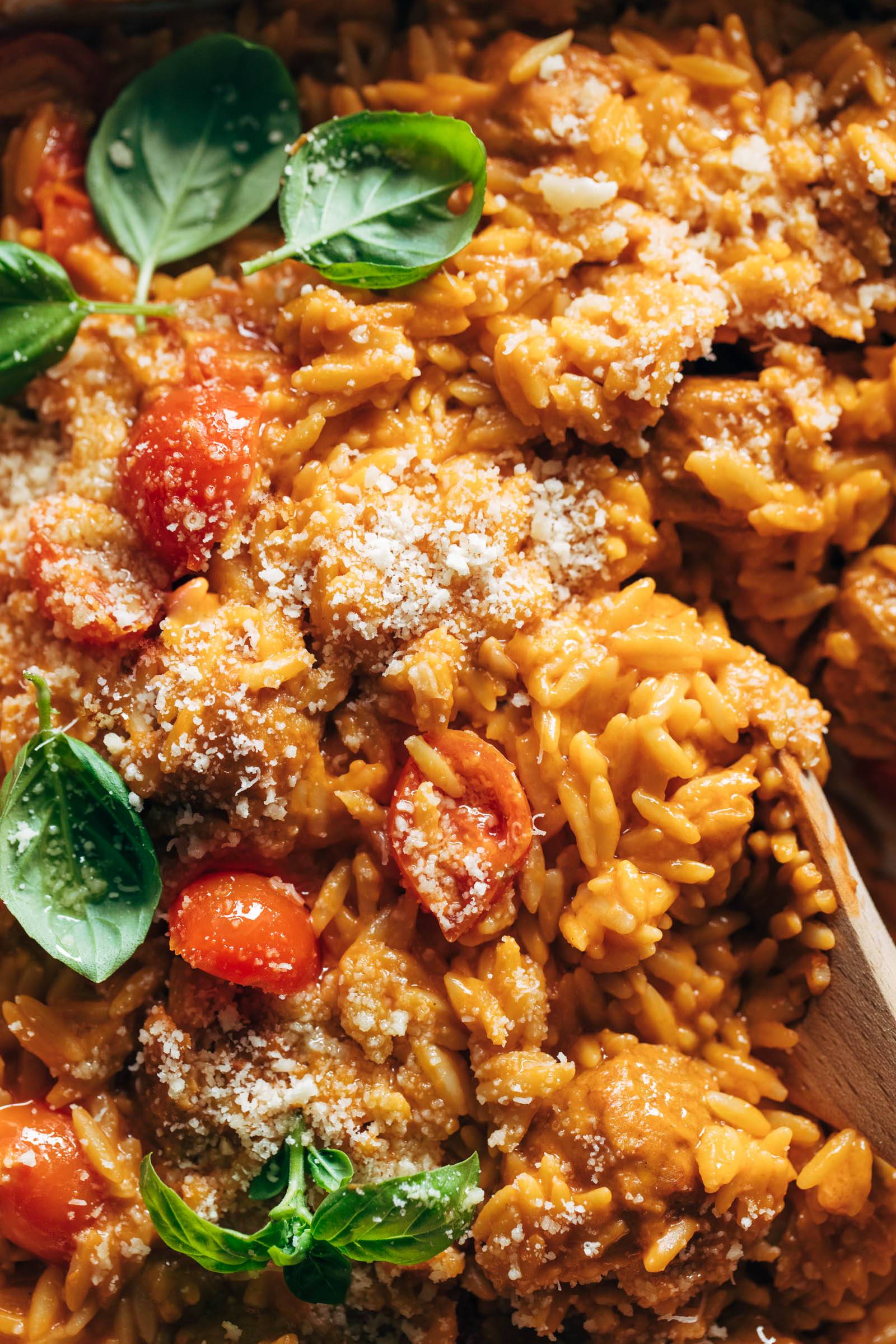 Close-up of creamy baked orzo with meatballs in a pan