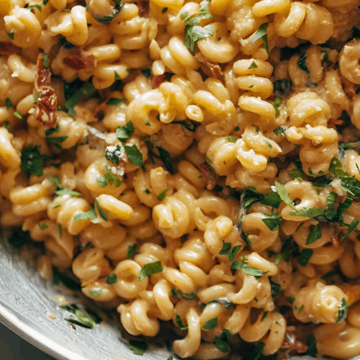 Creamy sun-dried tomato pasta in a pan.