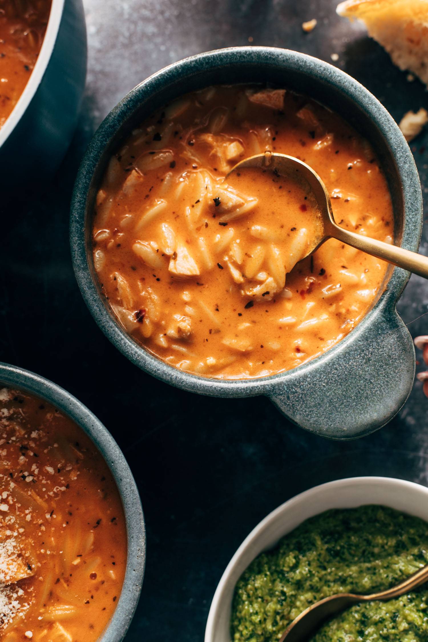 Chicken orzo soup in a bowl with a spoon