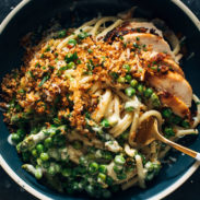 Bucatini in a bowl twirled on a fork