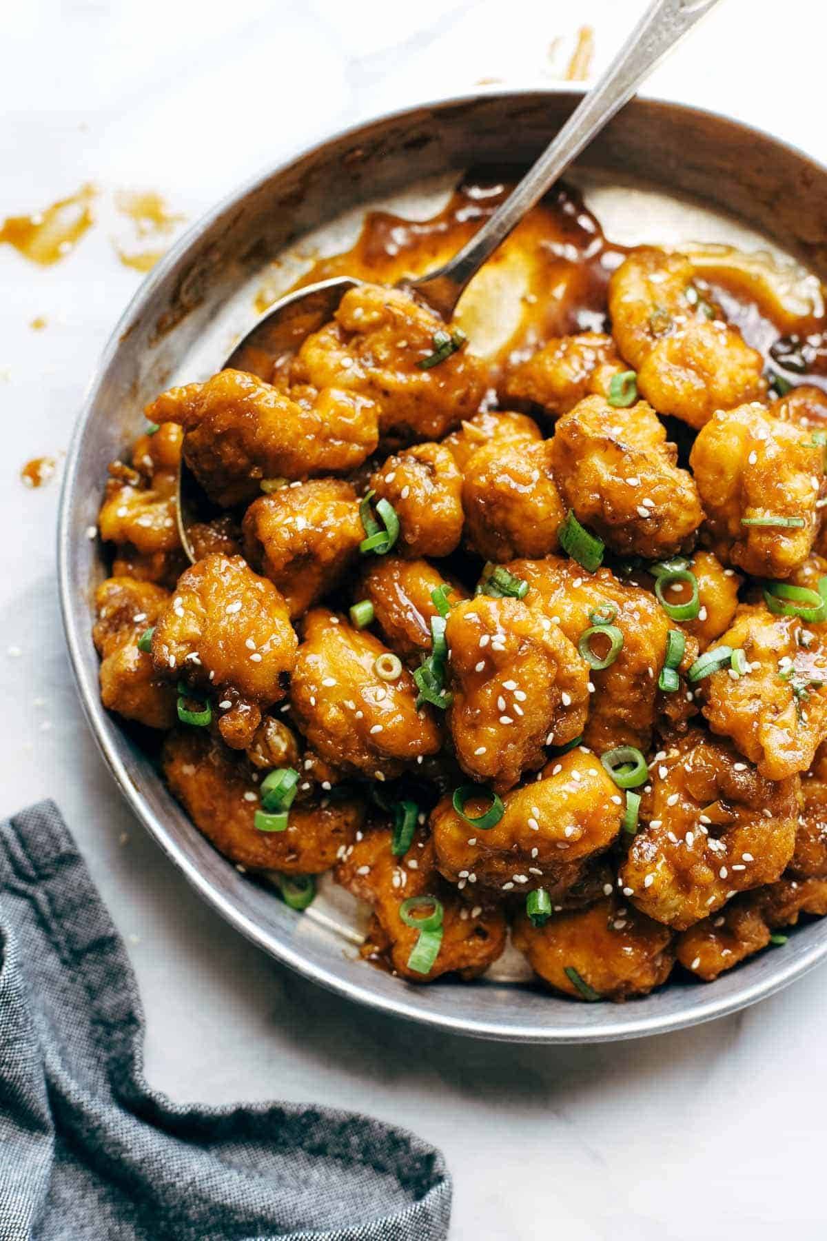 cauliflower on a plate with a spoon and a napkin