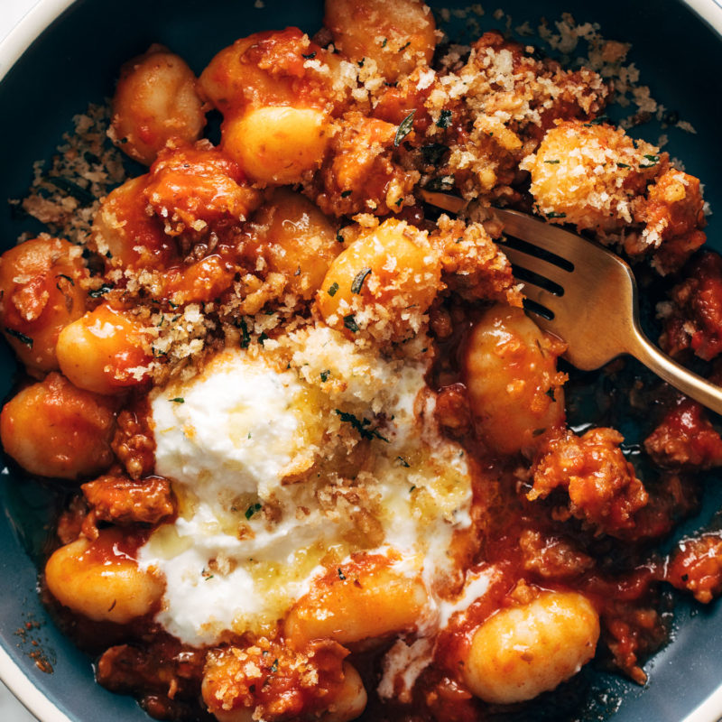 Gnocchi with red sauce and ricotta in a bowl.