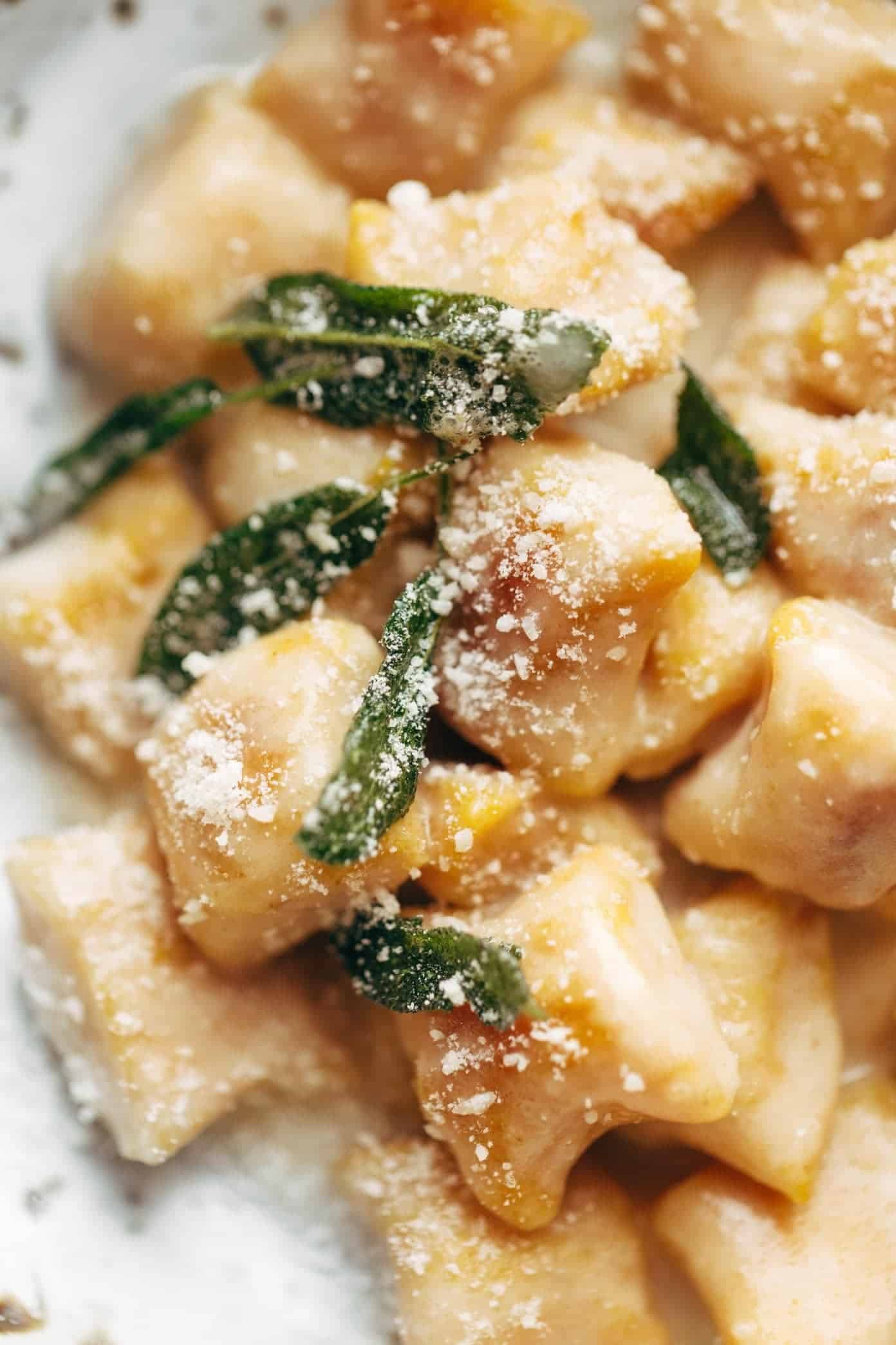 Pumpkin Gnocchi! So incredibly pillowy and delicious. Topped with a 5 ingredient sage garlic butter sauce that will blow your mind. | pinchofyum.com