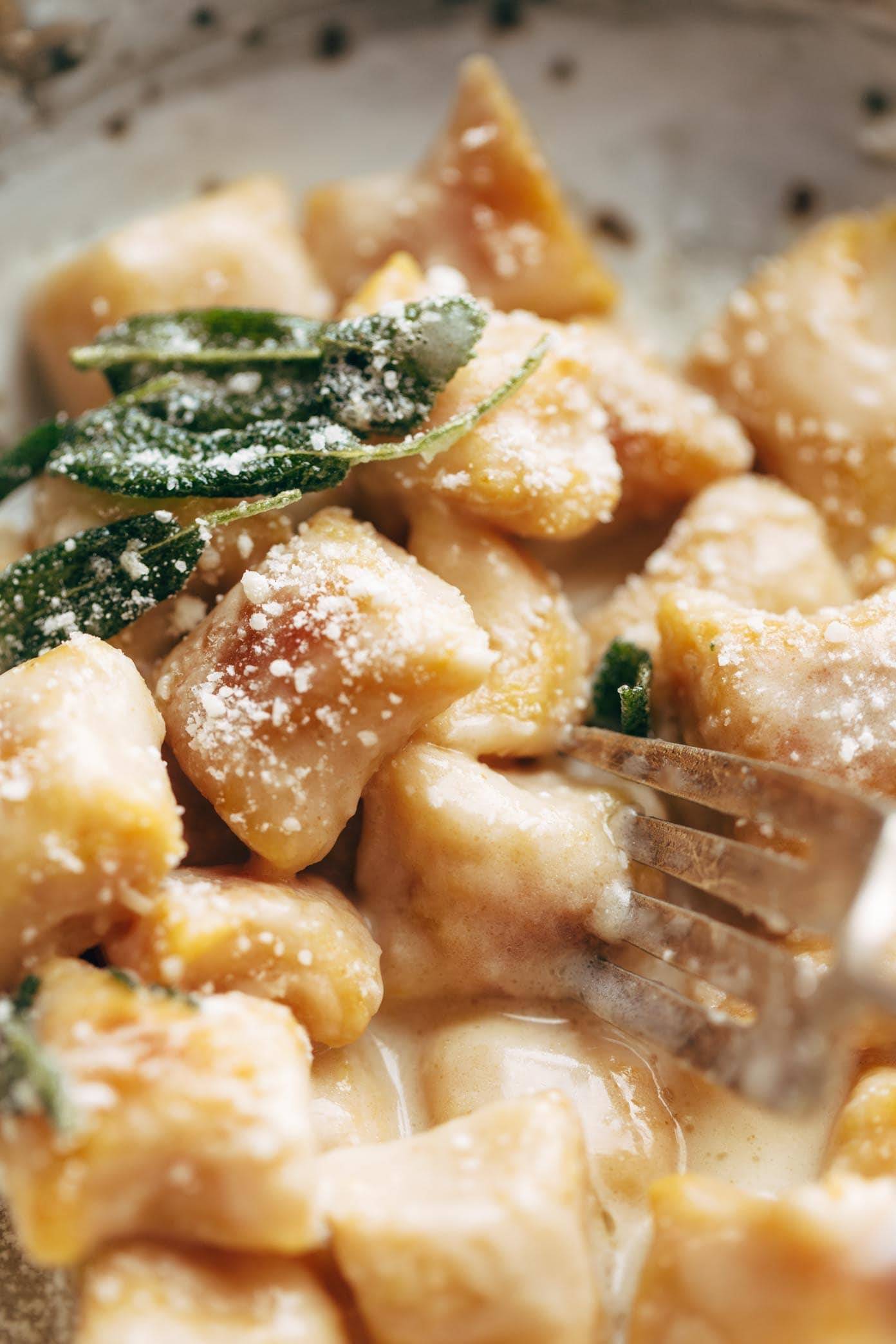 Pumpkin Gnocchi! So incredibly pillowy and delicious. Topped with a 5 ingredient sage garlic butter sauce that will blow your mind. | pinchofyum.com