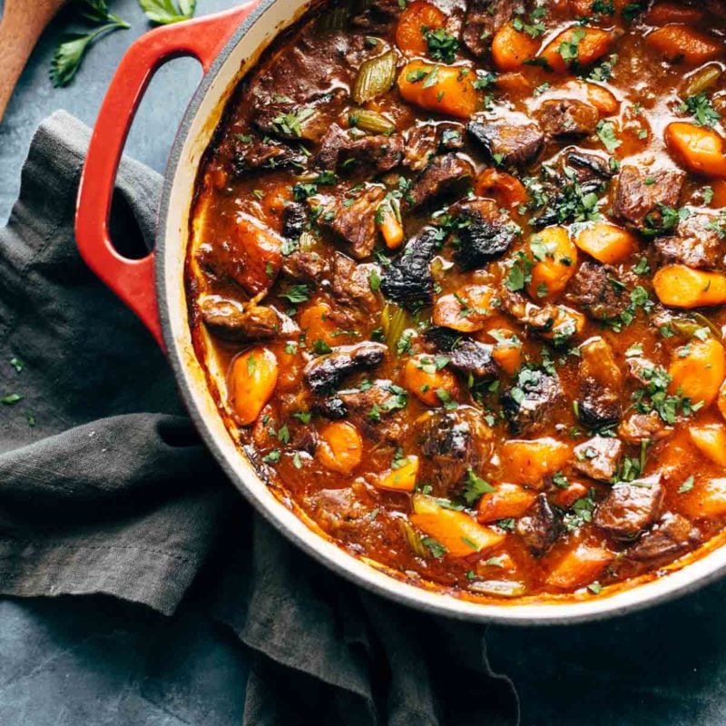 A pot of stew on a blue tablecloth.