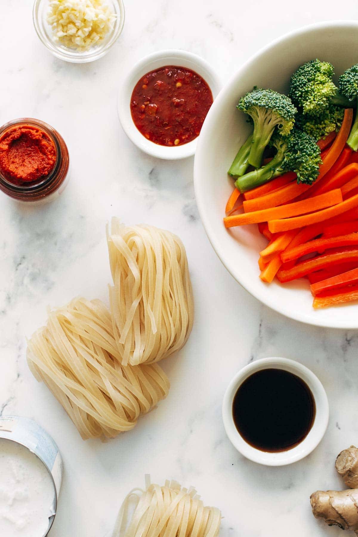 Ingredients in bowls for red curry noodles.