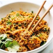 Gochujang noodles in a bowl with chopsticks.