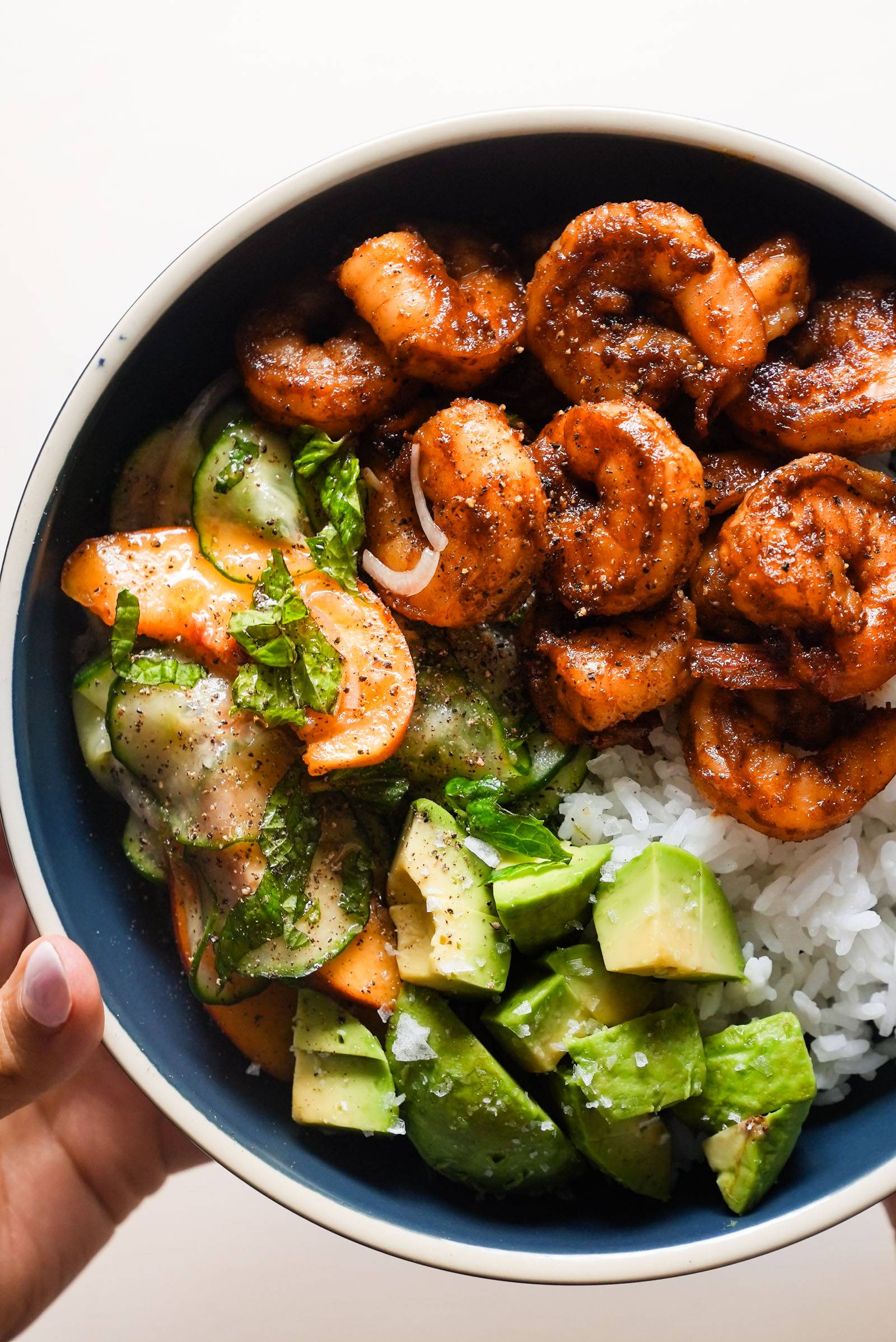 Shrimp in a bowl with rice and peach salad.