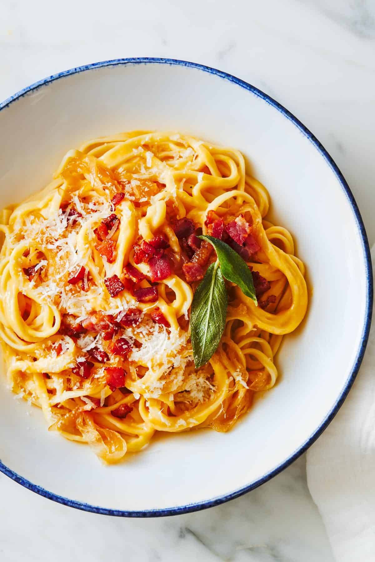 Squash Fettuccine with cheese and basil garnish in a bowl.