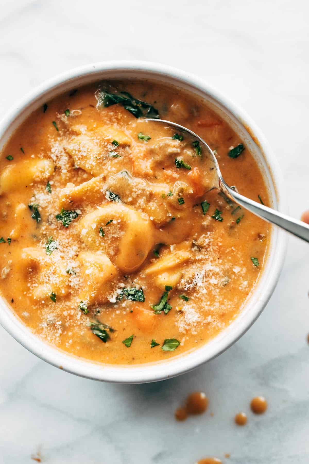 A large bowl of tortellini soup.