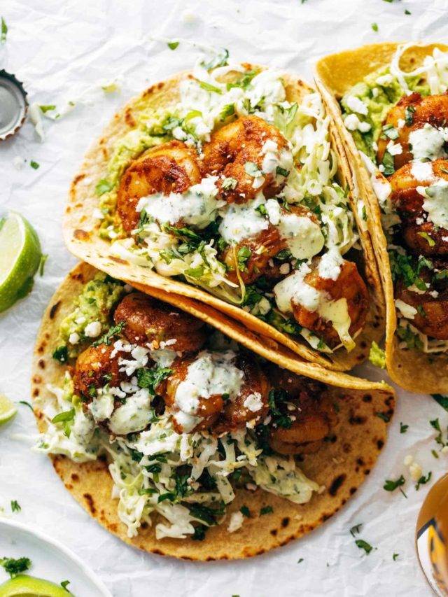 Spicy shrimp tacos with sauce.